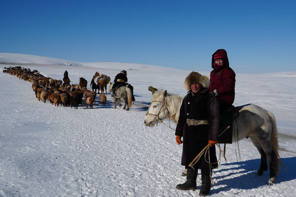 Hydirjan and fellow herders lead their animals across the snowy Altai — a winter migration in motion