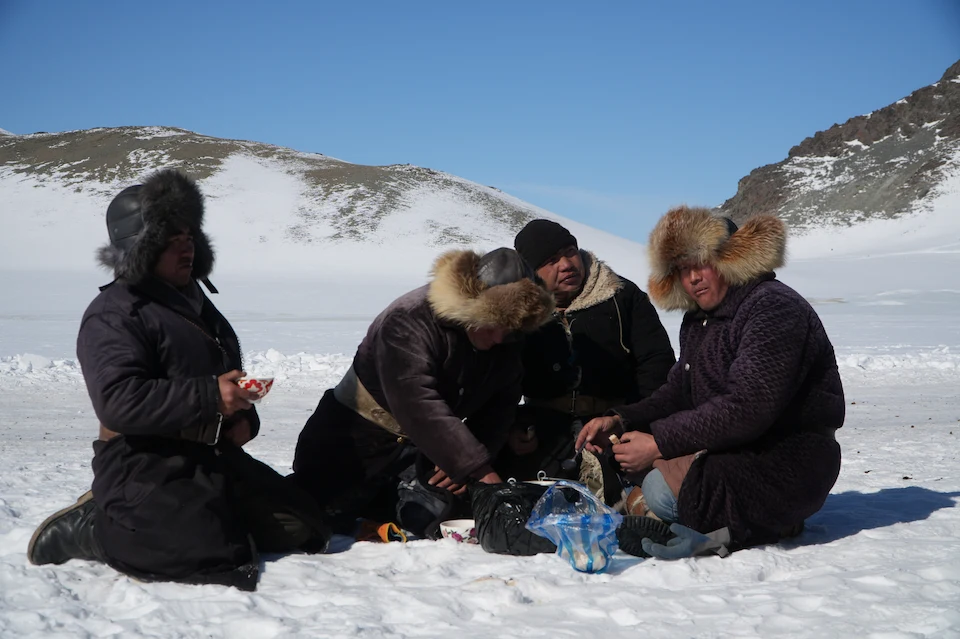 Eagle hunters pause during their winter migration, a rare glimpse into nomadic life in Mongolia's Altai