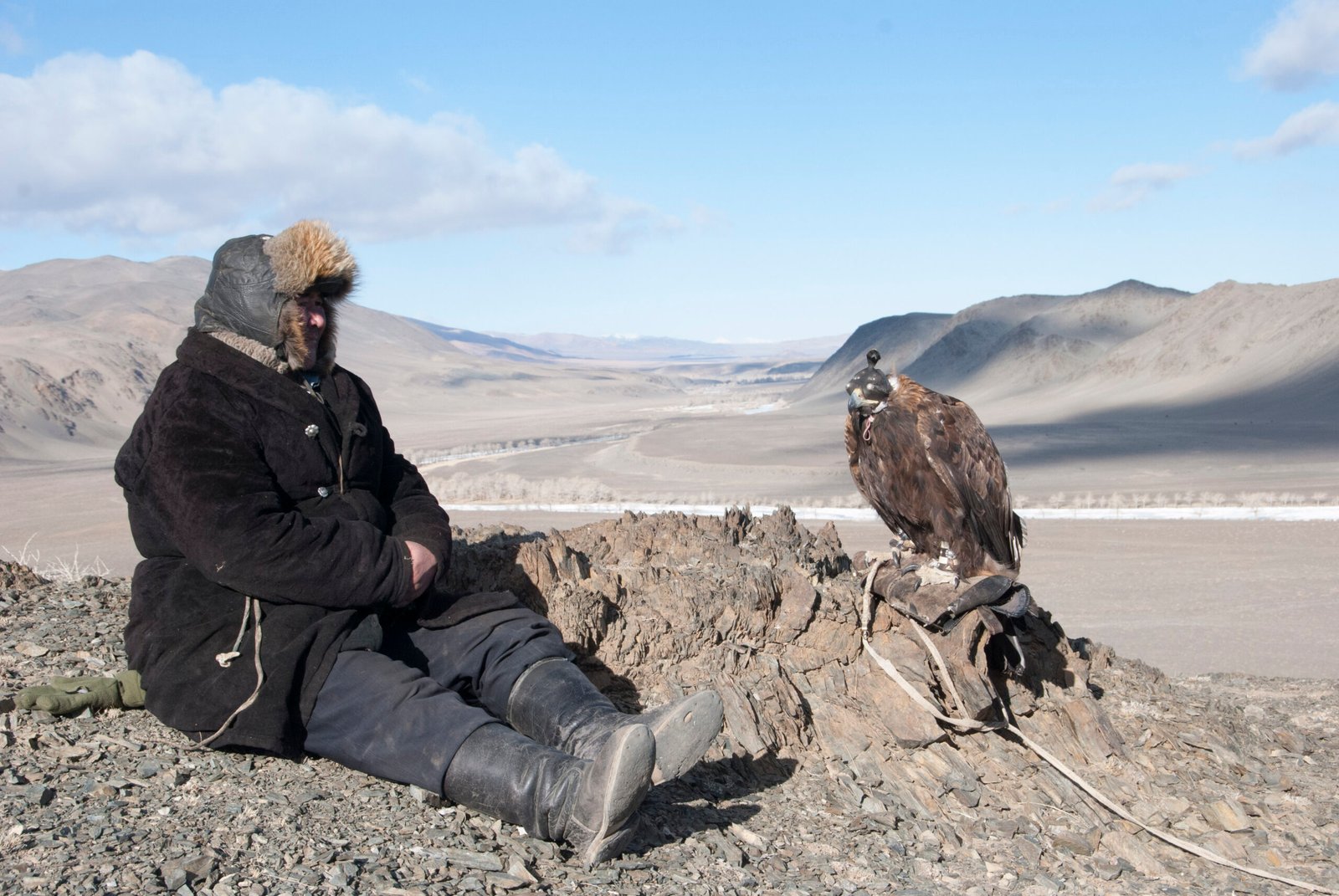 Kazakh eagle hunter with his golden eagle in the Altai Mountains of Western Mongolia
