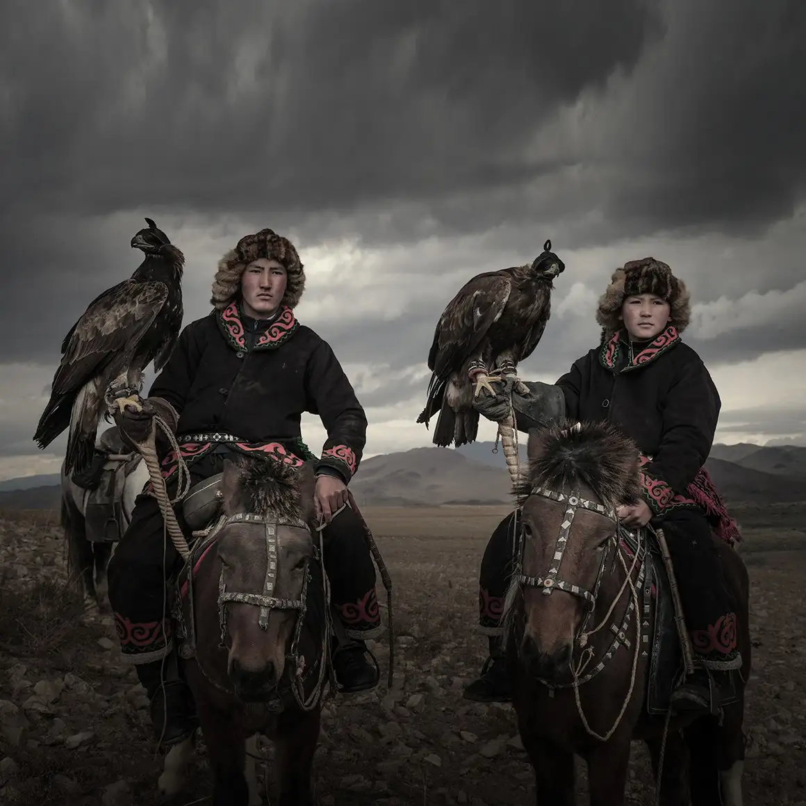 Kazakh eagle hunters on horseback at the Golden Eagle Festival in Bayan-Ölgii